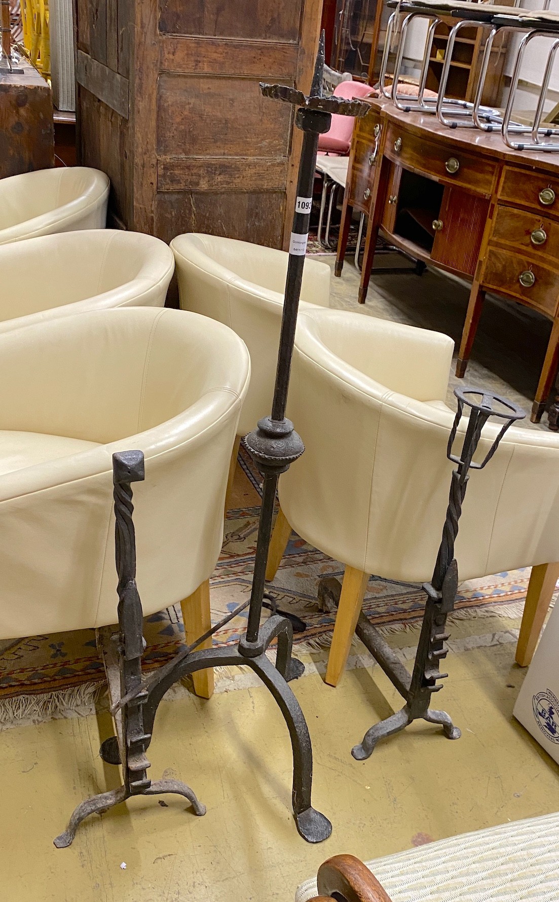 A wrought iron tripod pricket candlestick, height 138cm, together with a pair of andirons and a snuffer